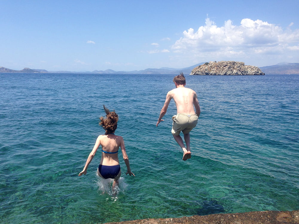 Couple jumping into the water.