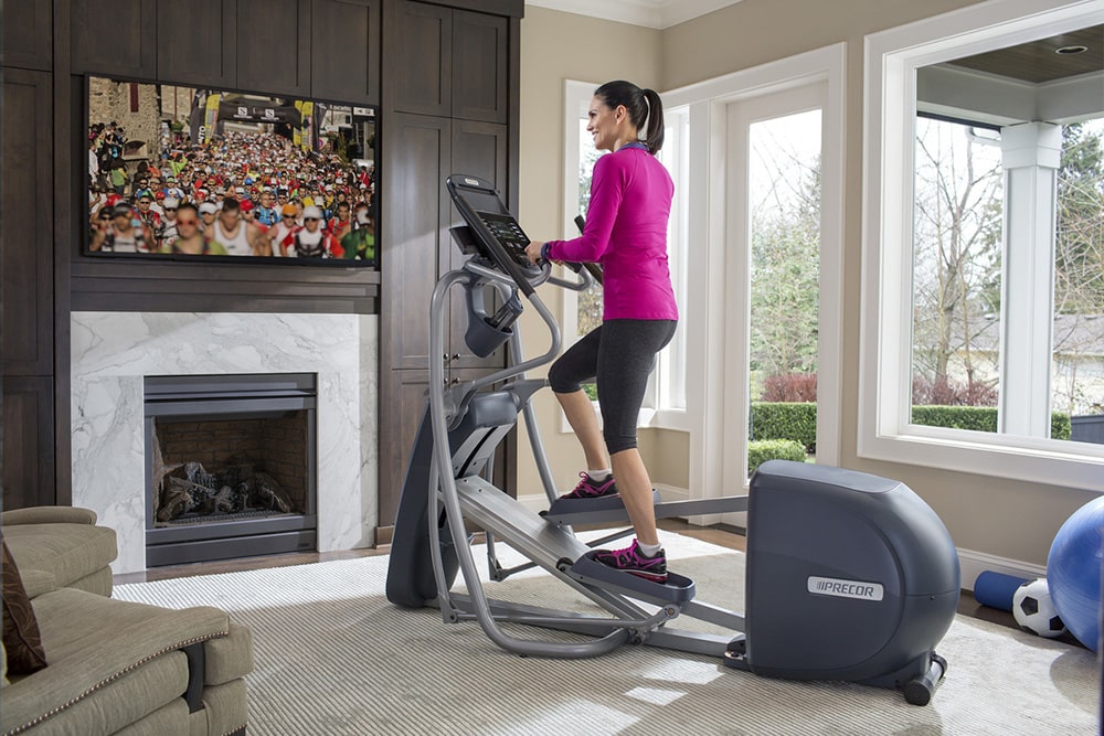 Woman working out on elliptical.