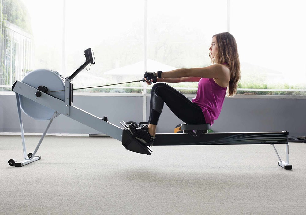 Woman working out on rowing machine.