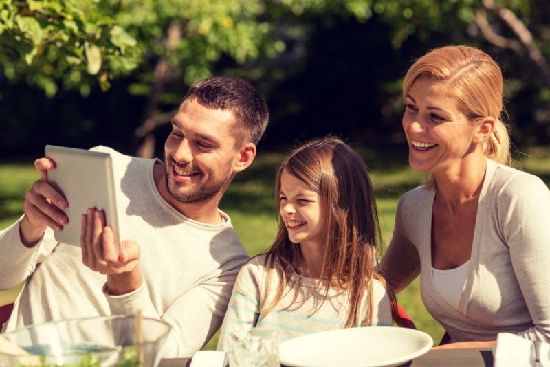 Family looking at the screen of tablet