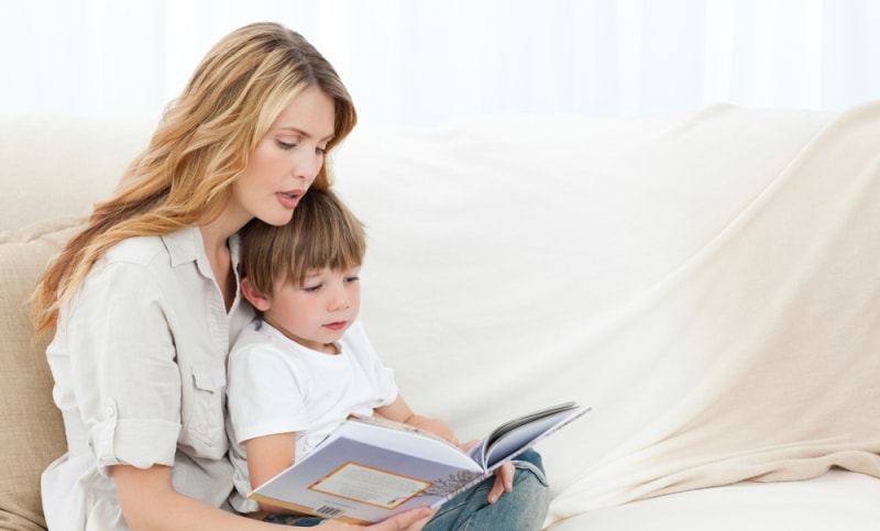 A mother reading to her son