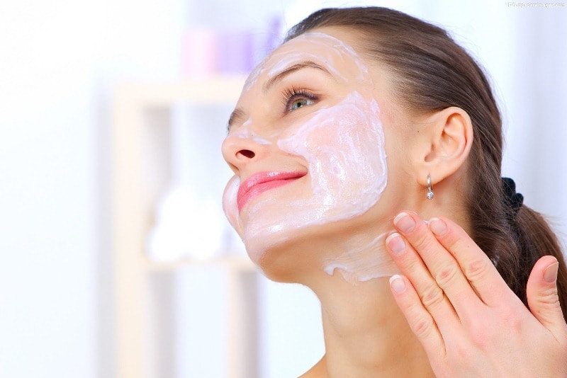 Woman applying face mask