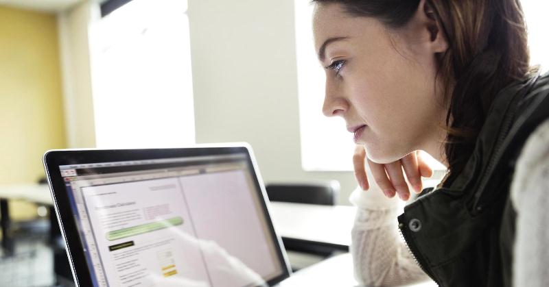 A girl looking at a monitor