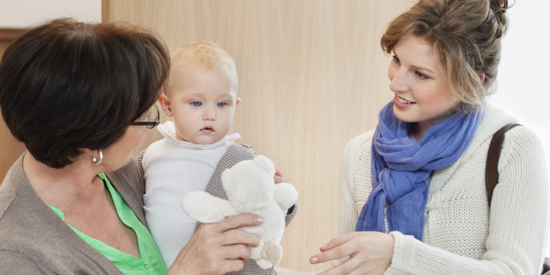 A lady looking at a child