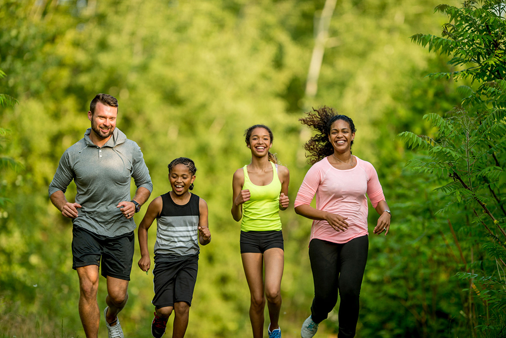 Family of four jogging.