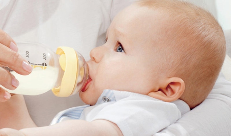 Mother feeding a baby from bottle