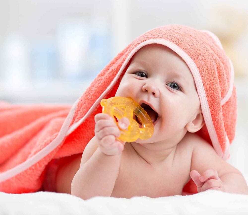 Baby with a teething ring.