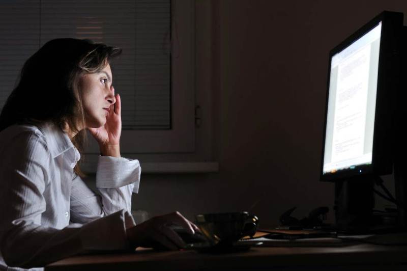 A lady looking at the screen 