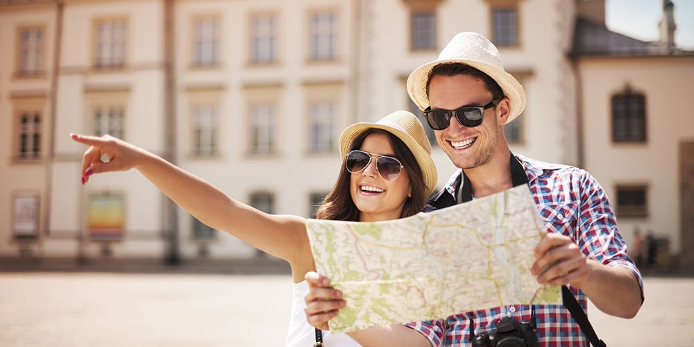 A woman pointing forward and a man holding a map.