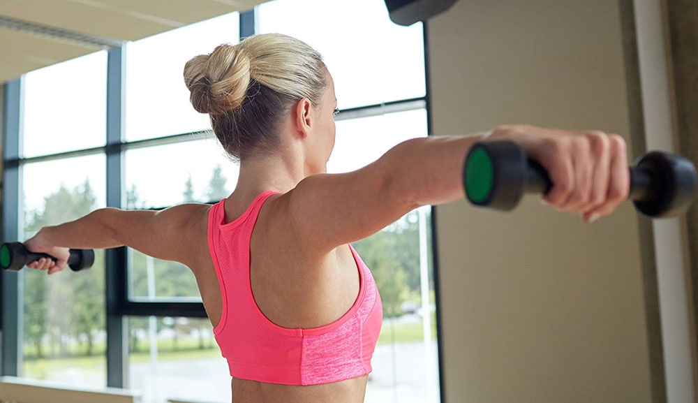 Woman working out with dumbbells.