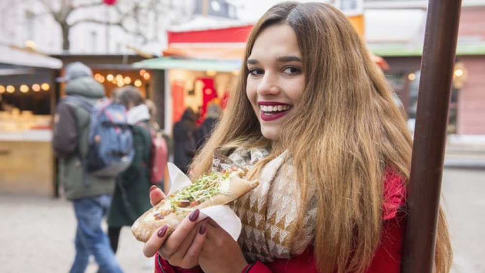 Woman eating street food.