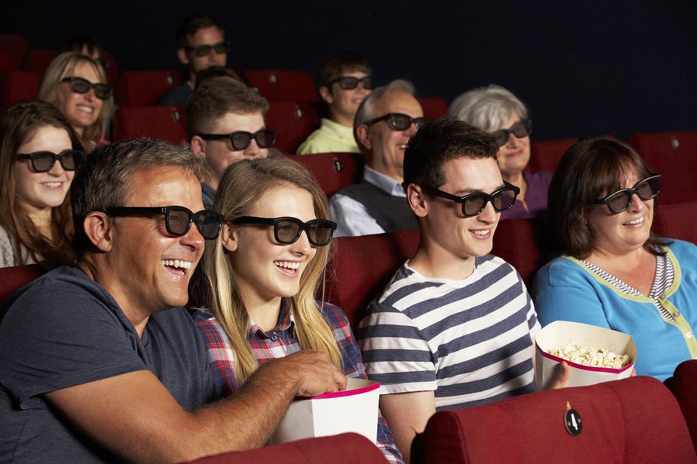 Family watching movie in the cinema.