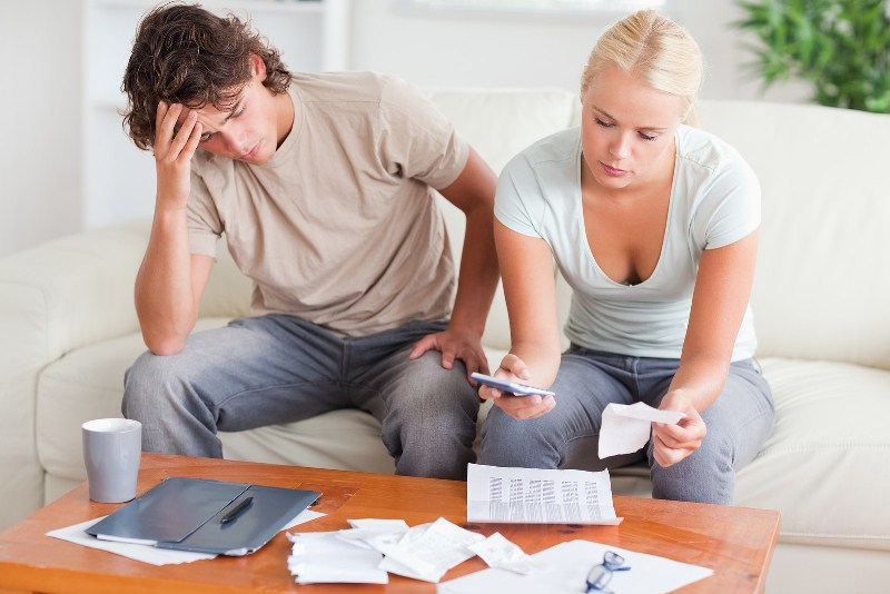 A man and a woman sorting the bills