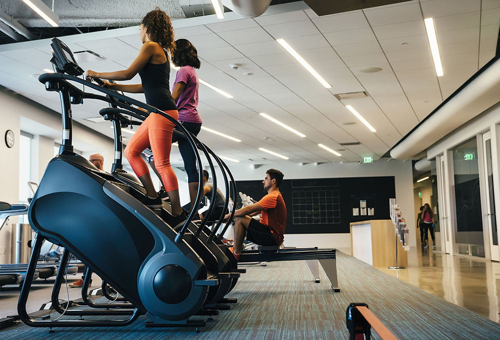 Women working out on stair mills.