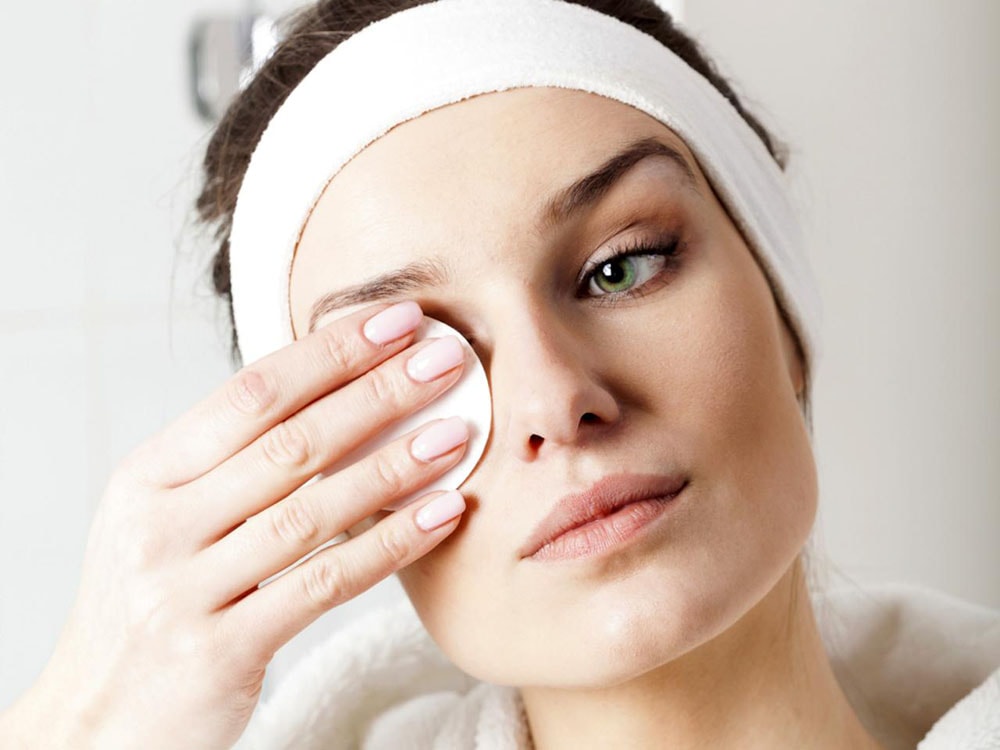 Woman taking off makeup.