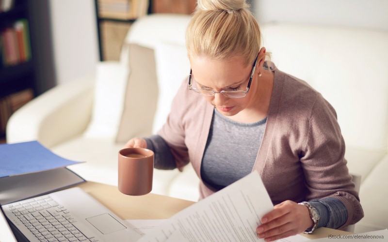 A woman looking at tax forms 