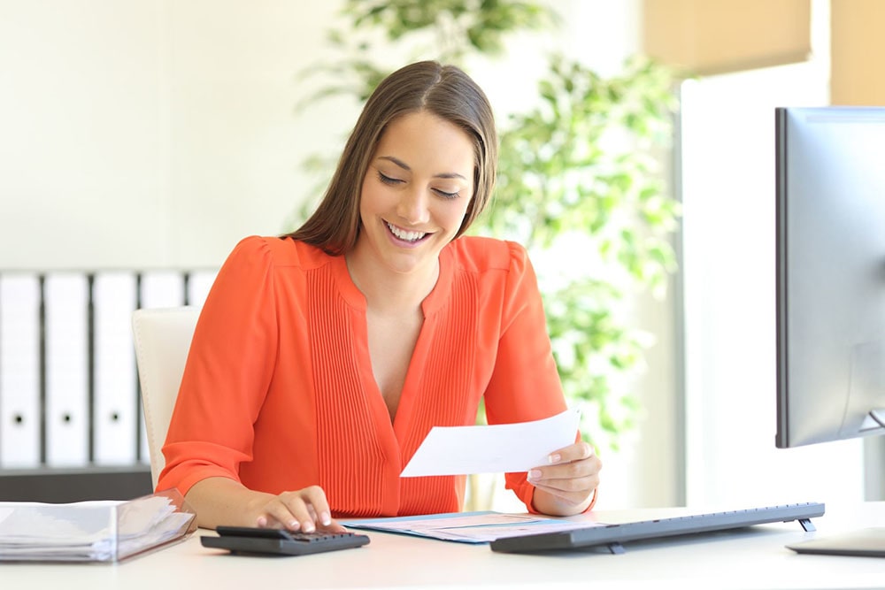 Woman calculating her taxes.