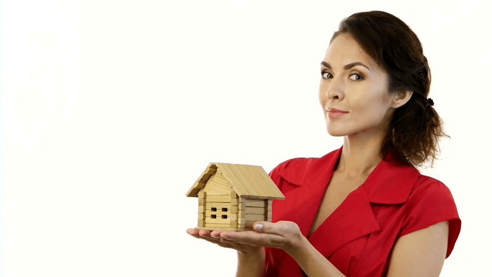 Woman holding a toy house.