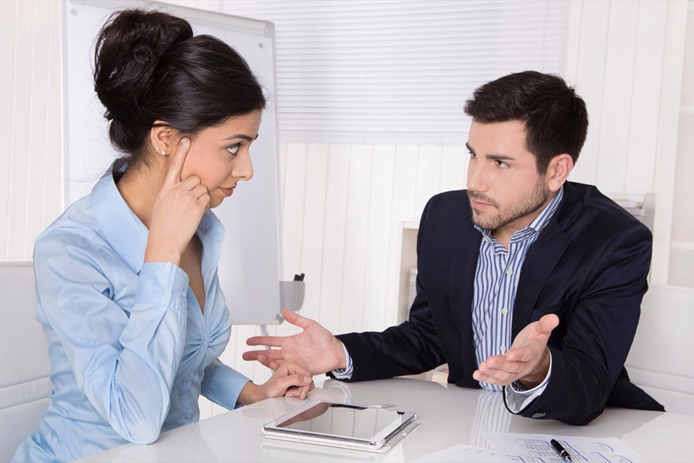 A man and a woman having a conversation.