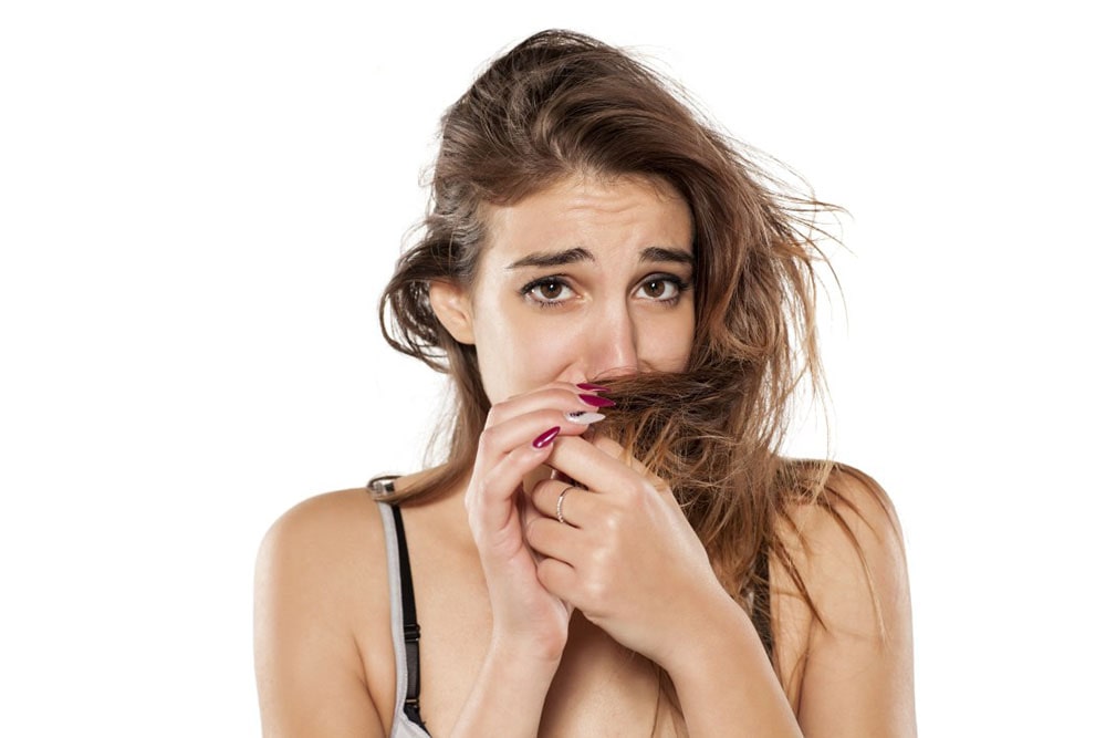 Woman smelling her hair.