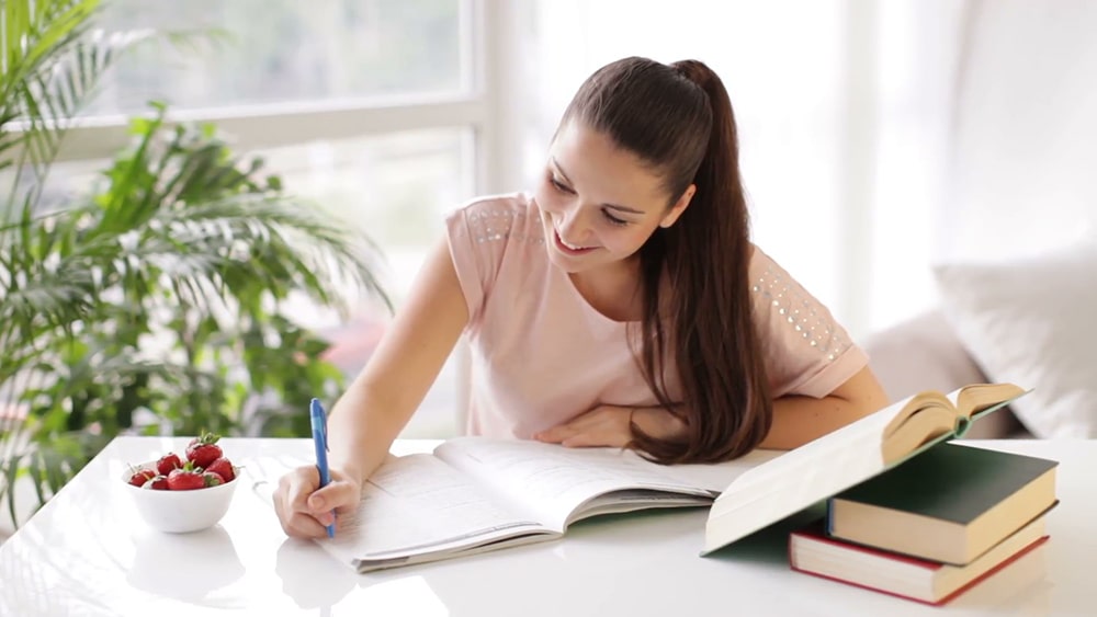 Woman writing in her notebook.