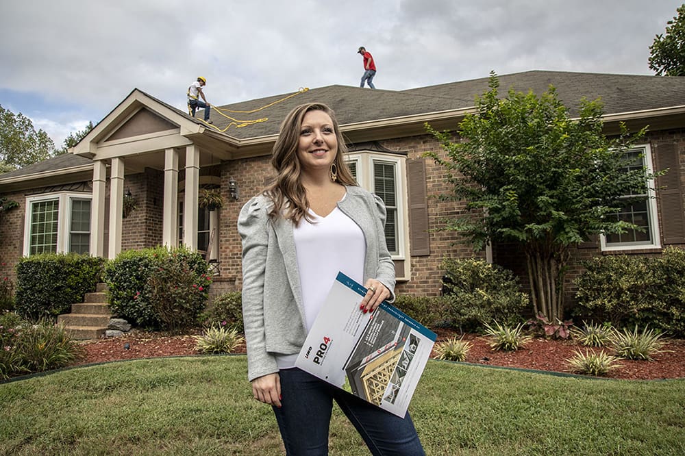 Woman controlling house roofing.